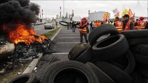 Striking workers of French oil giant Total set up a burning barricade to block the entrance of the oil refinery of Donges, near Nantes, October 18, 2010