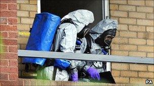 Officers in chemical suits at the flat in Putney on 30 September