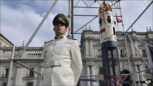 A police officer stands guard by the capsule outside the presidential palace in Santiago