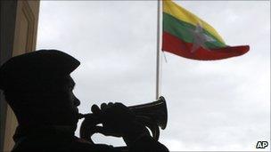 A soldier salutes the new Burmese flag in Yangon on 21 October 2010