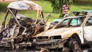 The burnt shells of cars after bombs exploded in Abuja, Nigeria, on Friday 1 October 2010.