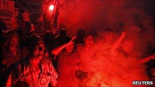 Demonstrators light flares during the protest in Buenos Aires