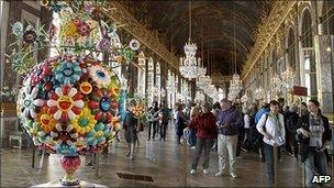 Visitors look at a Murakami work at Versailles