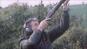 Man aiming shotgun