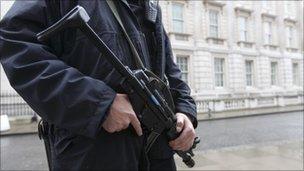 An armed police officer stands on duty in Downing Street, London