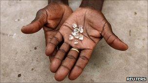 A diamond dealer shows his wares in Mozambique