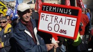 A protester in Bordeaux holds a placard reading: "Terminus: Retirement at 60" (20 Oct 2010)