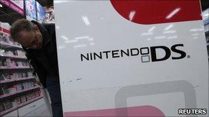 Man looking at Nintendo products in a store in Tokyo