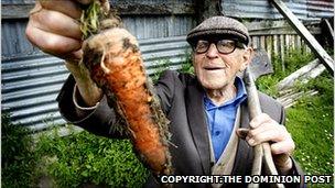 Man holding up a carrot