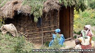 Batwa women outside a house