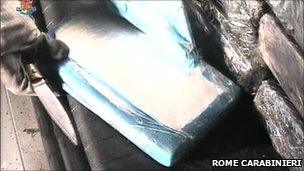 Italian police open one of the packages containing cocaine discovered in a container unloaded at Gioia Tauro port in southern Italy, 15 November 2010