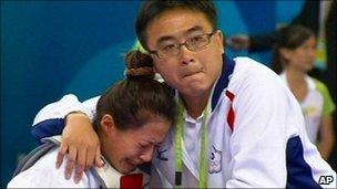 Taiwan's Yang Shu-Chun is consoled by her coach