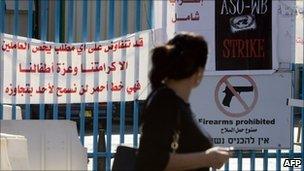 A woman walks past the closed gate of the UNRWA offices in Jerusalem, 26 October 2010