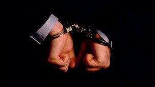 Generic image of handcuffs on a criminal