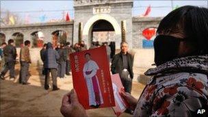 A woman shows a leaflet with picture of Guo Jincai in Chengde. Photo: 20 November 2010