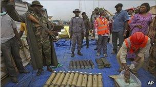 Nigerian soldiers and officials showing some of the arms seized at Apapa seaport in Lagos, 27 October 2010