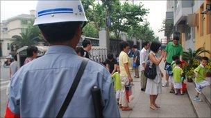 A guard at the entrance to Shanghai's Xiang Yin kindergarten