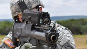 A US soldier holds the XM-25