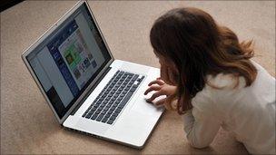 A young girl browses the internet