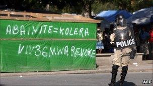 Haitian police patrol a street during a protest against the UN on November 19, 2010 in Port-au-Prince.