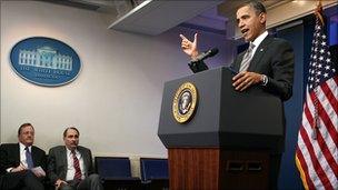 Robert Gibbs, right, and David Axelrod, centre listen to President Barack Obama talk about a tax cut deal