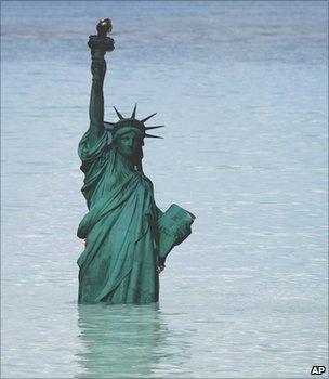 Environmental campaigners use models of famous landmarks to highlight potential impacts of climate change (Image: AP)