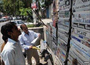 Pakistani men at newsstands in Islamabad