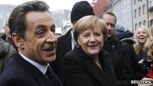 French President Nicolas Sarkozy (left) and German Chancellor Angela Merkel meet members of the public in Freiburg, 10 December