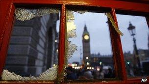 Houses of Parliament seen through broken window of phone box