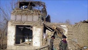 Afghan soldiers at damaged military checkpoint after a suicide attack in Kunduz, 11 December 2012