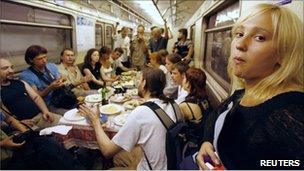 Voina holding a funeral feast on the Russian metro for a dissident poet in 2007