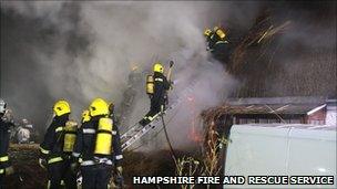 Firefighters at the thatched roof fire