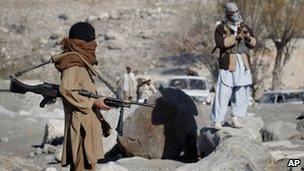 Taliban fighters man a checkpoint in Nangarhar province