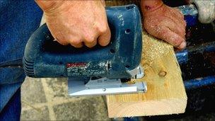 Worker using a jigsaw saw