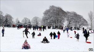 People sledging in the snow