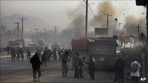 Afghan soldiers run for cover as a bomb explodes during a gun battle on the outskirts of Kabul, Afghanistan, on Sunday