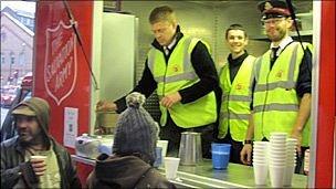 Luke Cozens (centre) serves tea with fellow Salvation Army volunteers