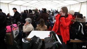 Passengers wait in a marquee outside Terminal 3
