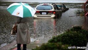 A person standing on a flooded street