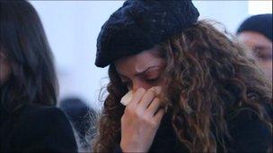 A woman weeps at the service in the Paris suburb of Montfermeil