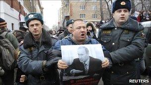 Russian policemen with a supporter of Mikhail Khodorkovsky