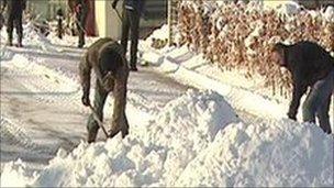 Men shovelling snow