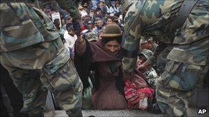 Soldiers help a woman on to a military truck during the strike in El Alto, Bolivia