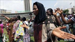 Women take part in a prayer session in Plateau, in Abidjan, 27 December 2010