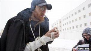 Belarus opposition activist Yan Logvinovich smokes a cigarette after being released from police custody, 29 December