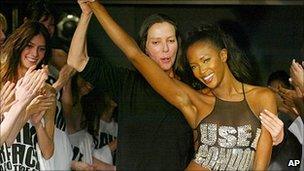 Katherine Hamnett holds up the arm of model Naomi Campbell; London Fashion Week Sept 2003