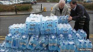 People holding bottled waters