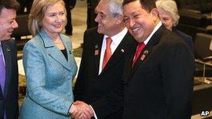 Venezuelan President Hugo Chavez (R) shakes hands with US Secretary Hillary Clinton, who stands between Colombian President Manuel Santos (L) and Chilean President Sebastian Pinera during Brazilian President-elect Dilma Rousseff's inauguration in Brasilia, Brazil