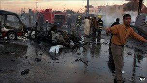 Iraqi fire fighters extinguish the fire at the site of a car bomb explosion in the Shiite district of Sadr city, in Baghdad, Iraq, Sunday, March 12, 2006