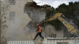 Israeli bulldozers demolish the Shepherd Hotel in Sheikh Jarrah, east Jerusalem, 9 January